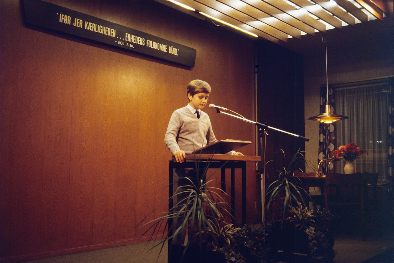 hero-img-01 A young boy delivers a speech at a podium in Aarhus, Denmark.